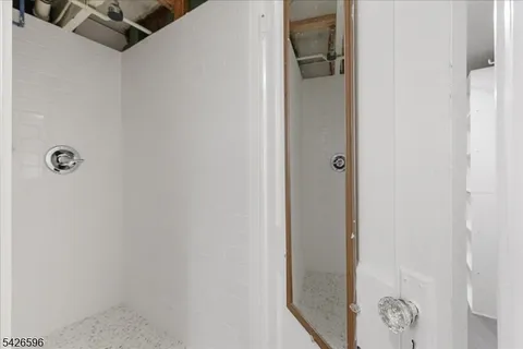 a bathroom with a glass shower door