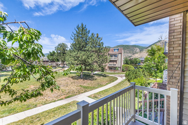 88 West 50 South, Unit C8 Centerville, UT 84014 - Photo 20 of 29 Private balcony with white railing overlooking a shared green space and paved pathway