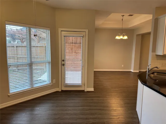 a view of a kitchen with a dishwasher cabinets and wooden floor