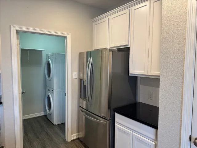 a metallic refrigerator freezer sitting in a kitchen