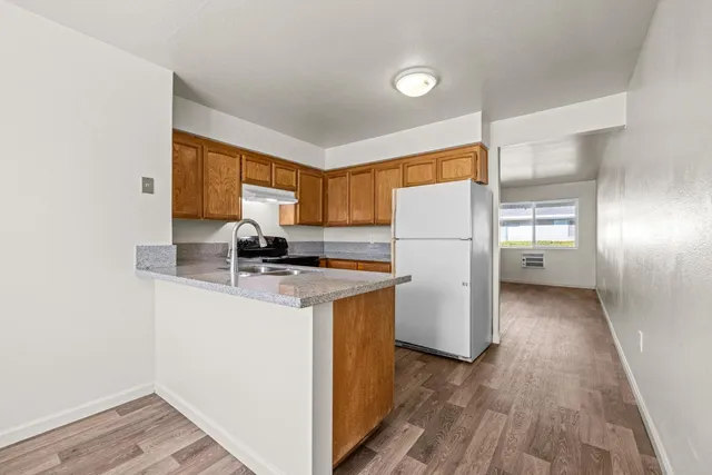 a view of a hallway with wooden floor
