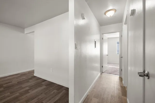 a bathroom with a granite countertop sink mirror vanity and toilet