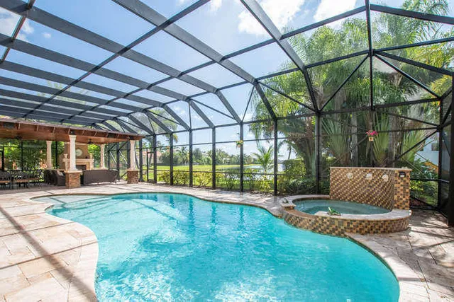 a open kitchen with stainless steel appliances granite countertop a stove kitchen island a table and chairs