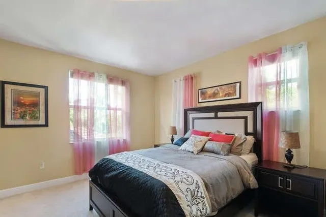 a bedroom with a bed and window