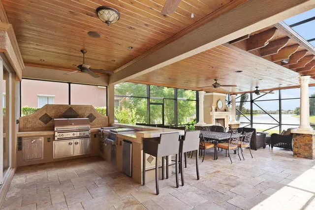 a living room with furniture a fireplace and a large window