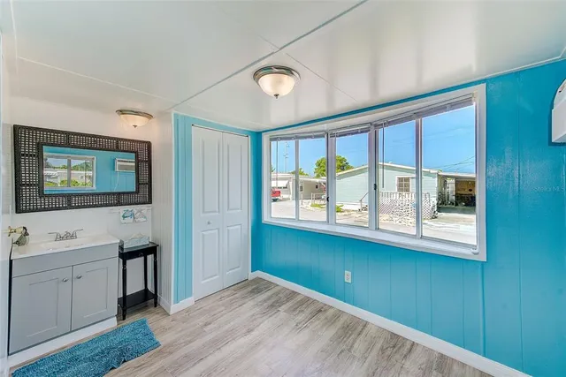 a view of a room with wooden floor and cabinet
