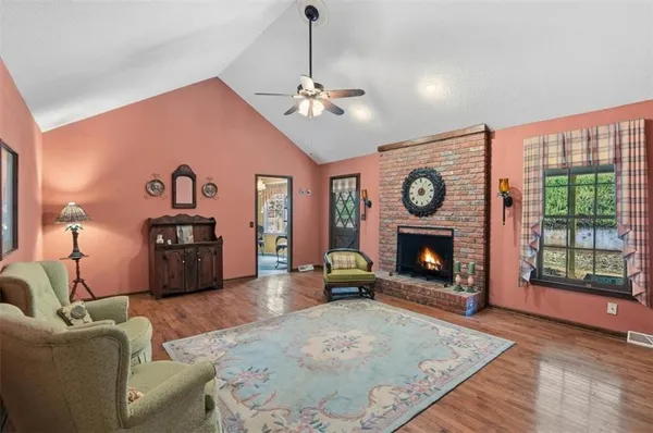 a living room with furniture a window and a fireplace