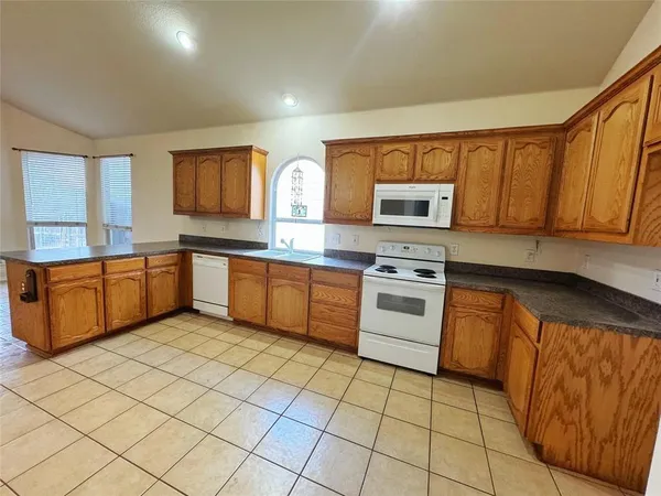 a kitchen with stainless steel appliances granite countertop a stove sink and cabinets