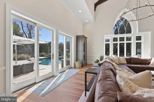 a living room with furniture and large windows