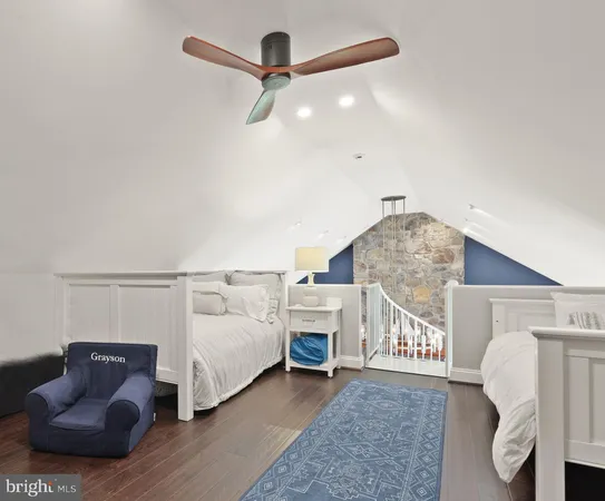 a living room with furniture and a ceiling fan