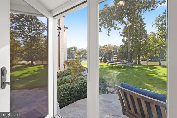 a view of a porch with a big yard and potted plants