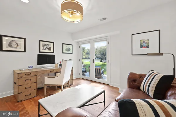a living room with furniture a flat screen tv and a large window