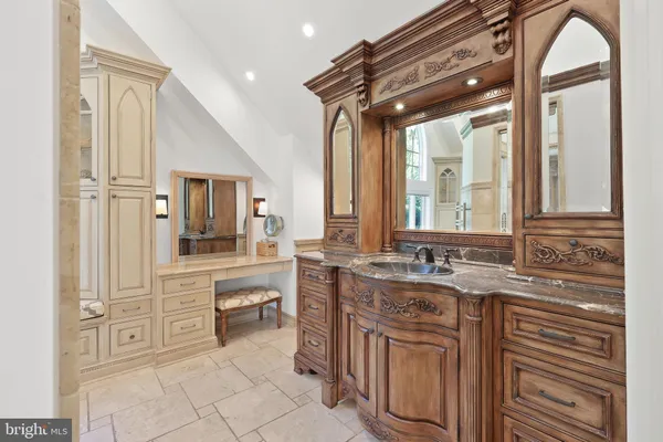 a bathroom with a granite countertop sink mirror and a bathtub