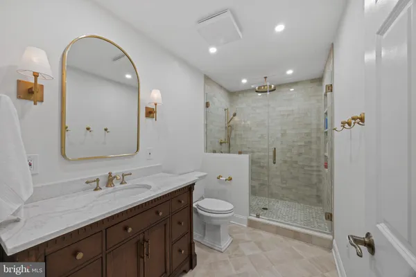 a bedroom with a bed and a table with wooden floor