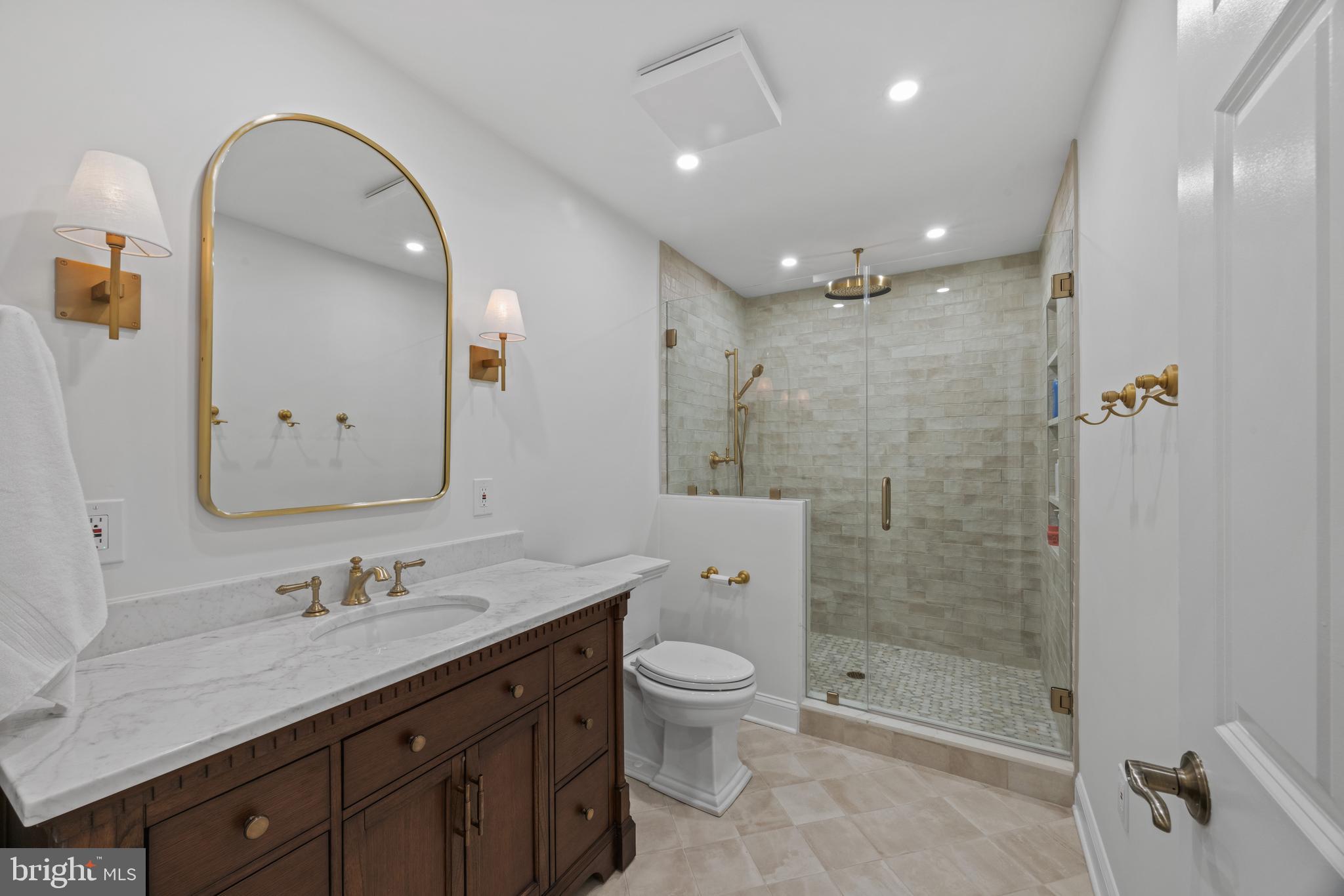 1524 Cedar Lane Farm Road Annapolis, MD 21409 - Photo 46 of 50 a spacious bathroom with a shower sink vanity mirror and toilet