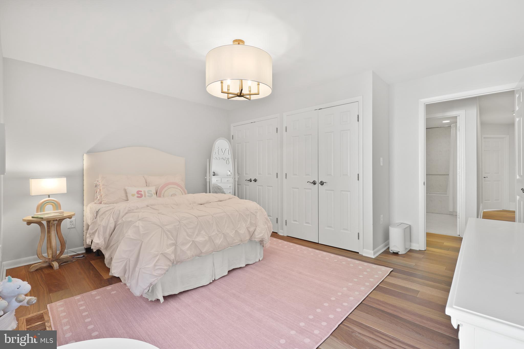 1524 Cedar Lane Farm Road Annapolis, MD 21409 - Photo 47 of 50 a bedroom with a bed and a table with wooden floor