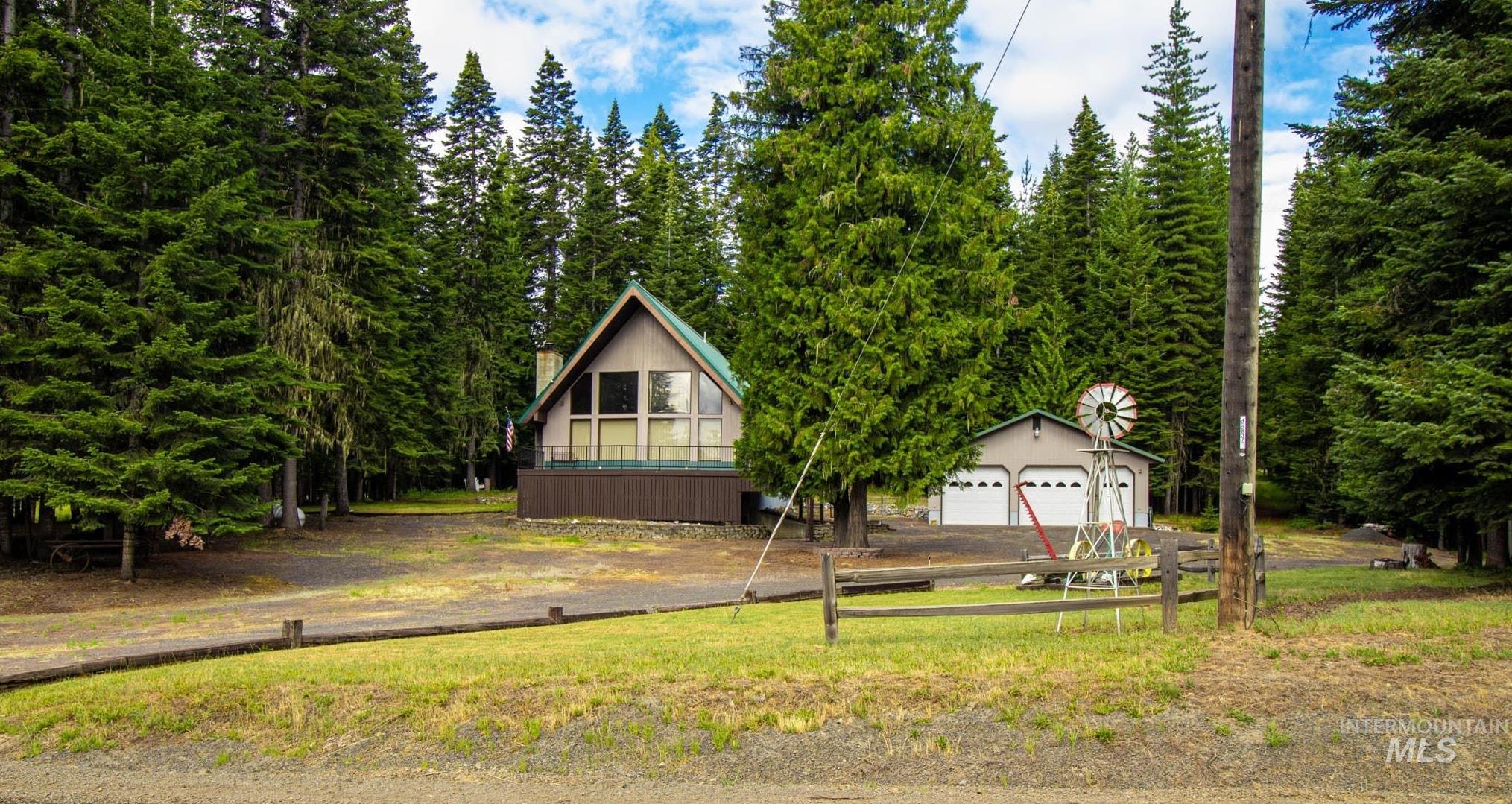 20888 Upper Fords Creek Road Weippe, ID 83553 - Photo 1 of 50 View of front of house with a garage and view of scattered trees