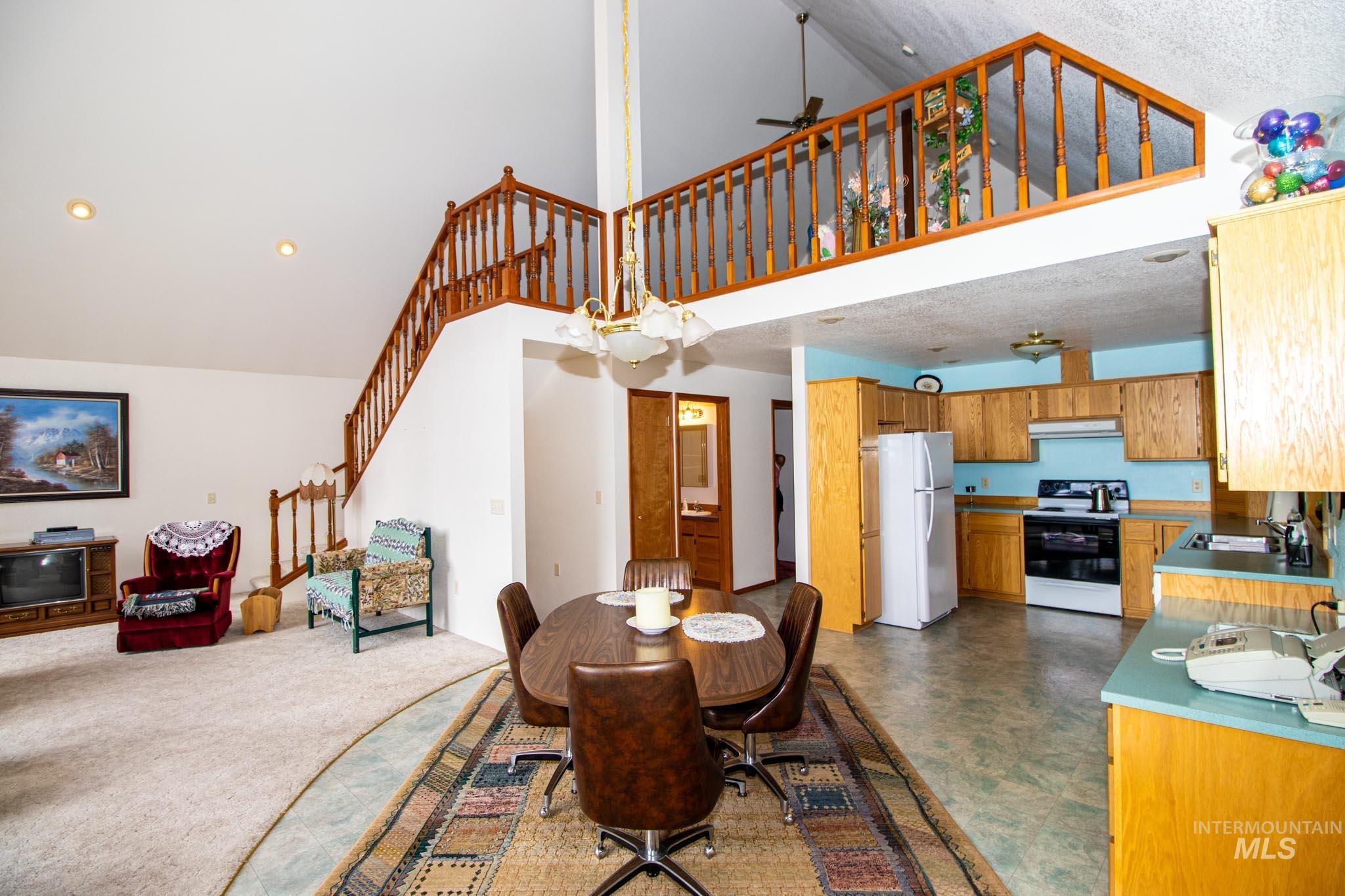 20888 Upper Fords Creek Road Weippe, ID 83553 - Photo 12 of 50 Dining area with a ceiling fan, a high ceiling, and recessed lighting