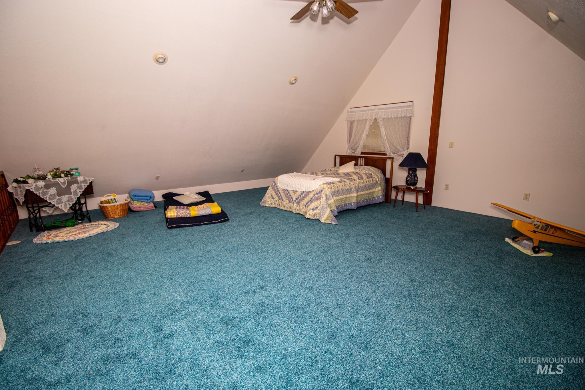 20888 Upper Fords Creek Road Weippe, ID 83553 - Photo 19 of 50 Unfurnished bedroom featuring carpet floors, ceiling fan, and vaulted ceiling