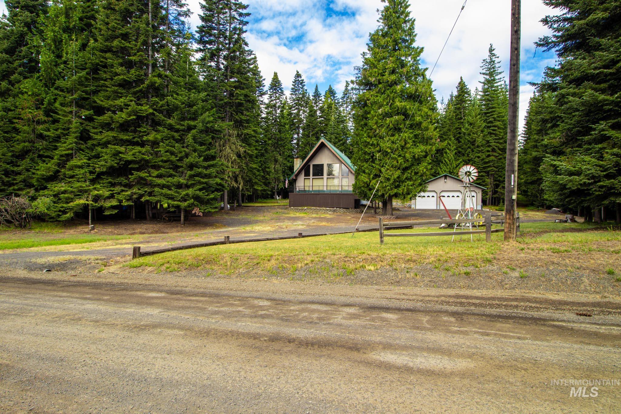 20888 Upper Fords Creek Road Weippe, ID 83553 - Photo 2 of 50 View of yard with a detached garage and view of scattered trees