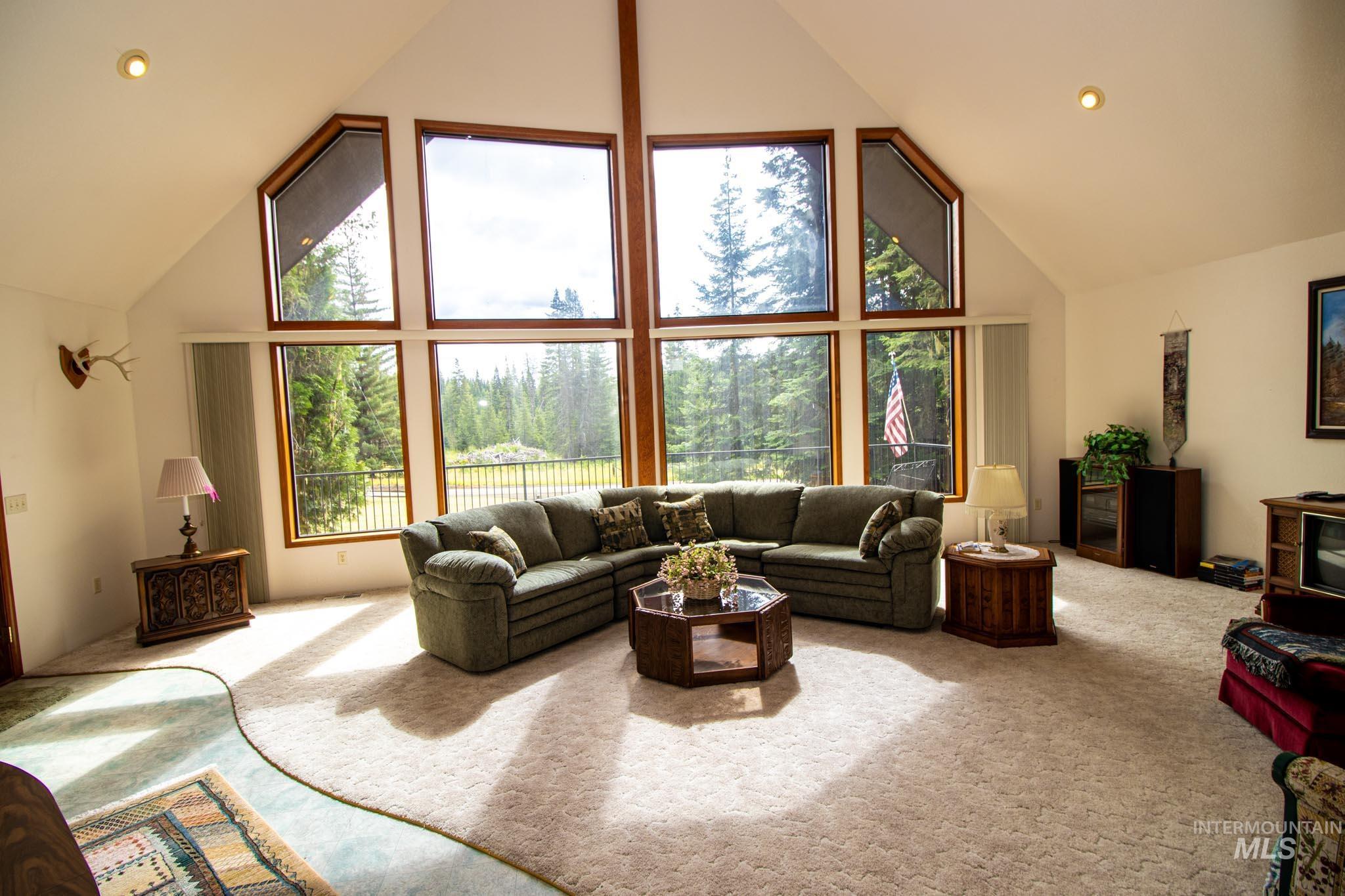 20888 Upper Fords Creek Road Weippe, ID 83553 - Photo 3 of 50 Carpeted living area with a high ceiling, recessed lighting, and plenty of natural light