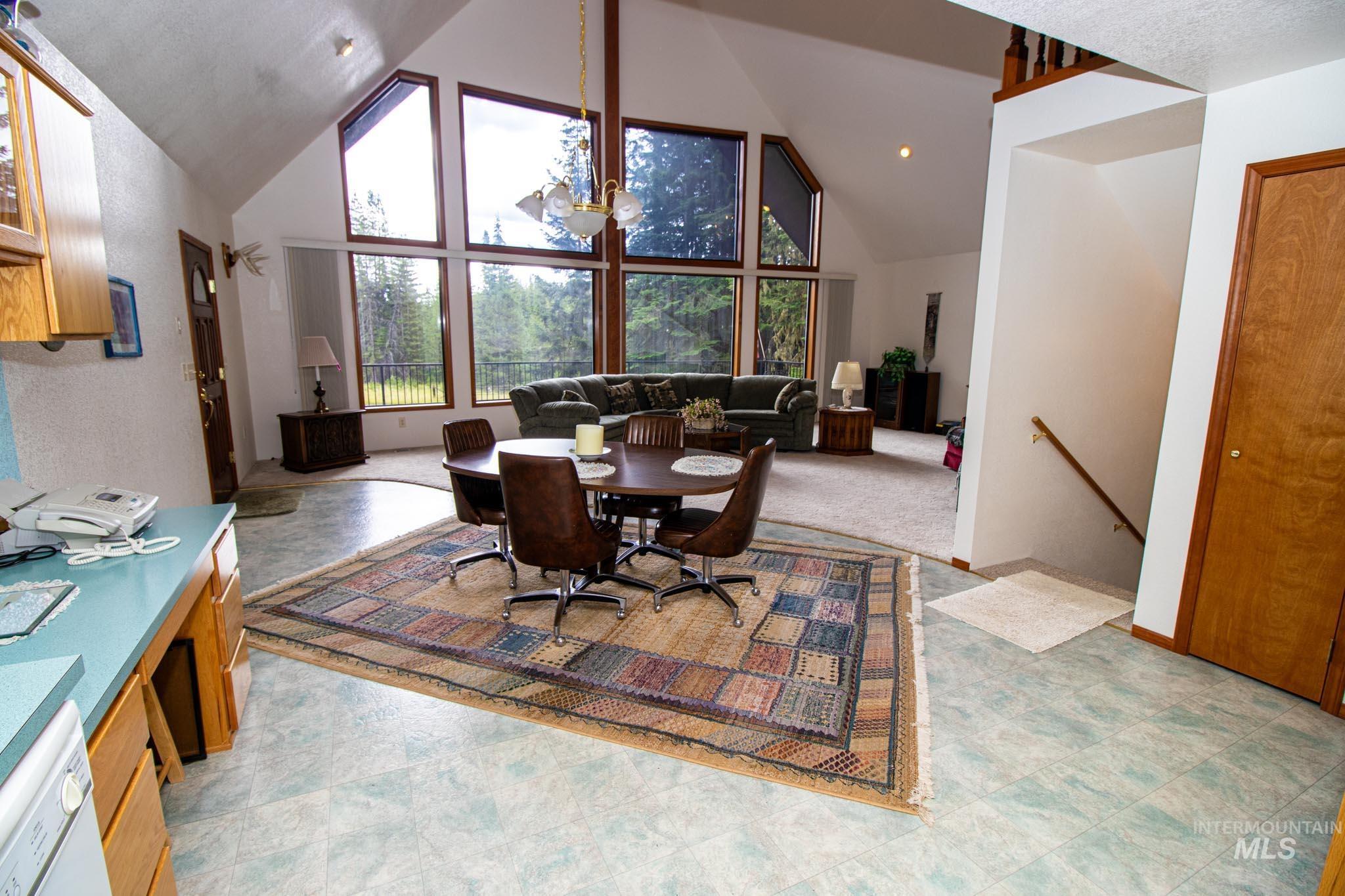 20888 Upper Fords Creek Road Weippe, ID 83553 - Photo 6 of 50 Dining room featuring a high ceiling, plenty of natural light, and light floors