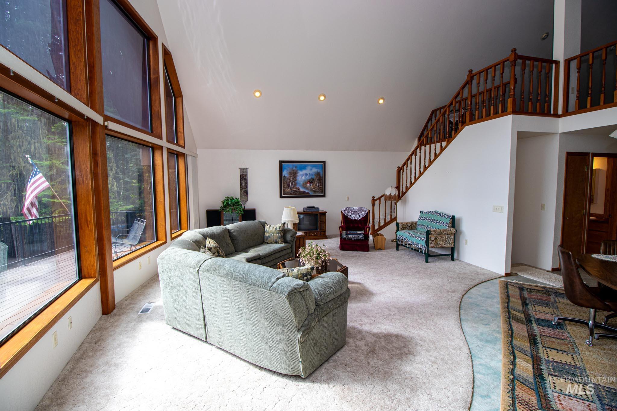 20888 Upper Fords Creek Road Weippe, ID 83553 - Photo 9 of 50 Carpeted living area with vaulted ceiling and recessed lighting