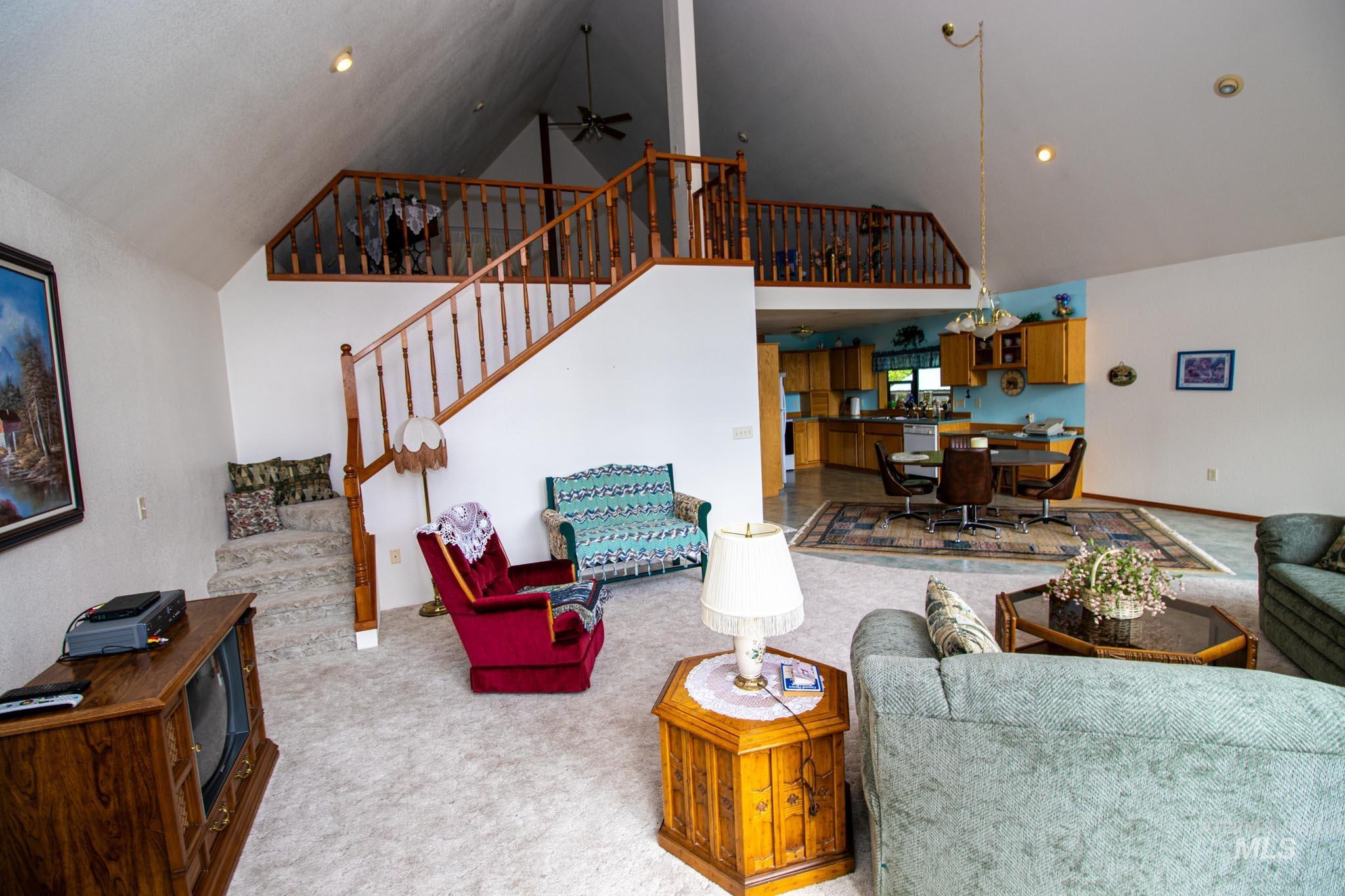 20888 Upper Fords Creek Road Weippe, ID 83553 - Photo 10 of 50 Living room with ceiling fan, carpet, vaulted ceiling, and recessed lighting