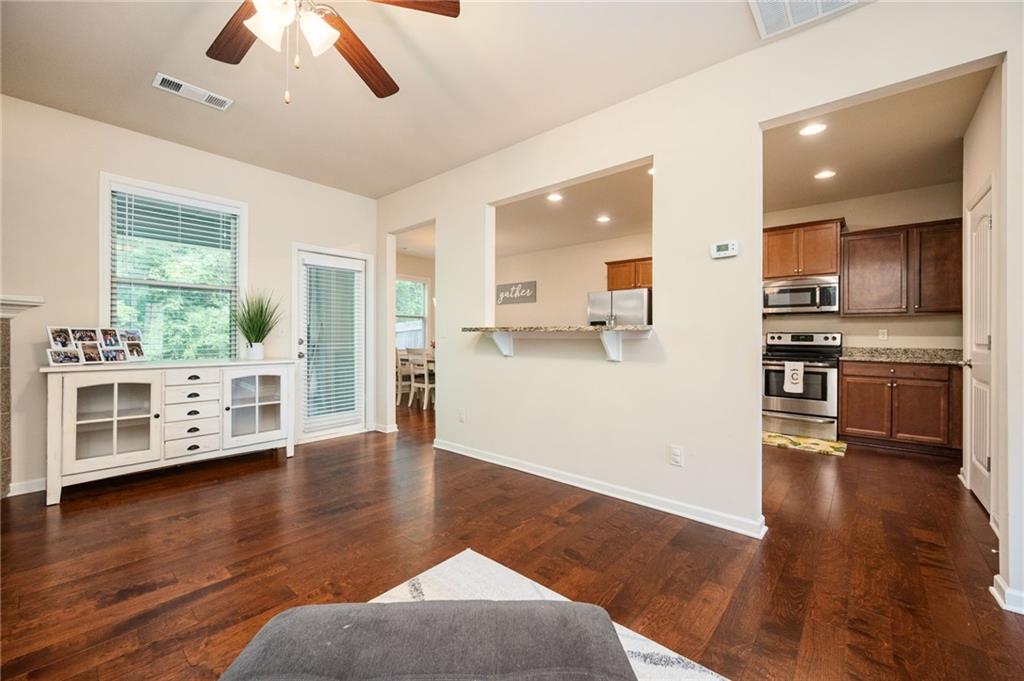 403 Franklin Lane Acworth, GA 30102 - Photo 12 of 26 a view of a kitchen with a stove wooden cabinets and a living room