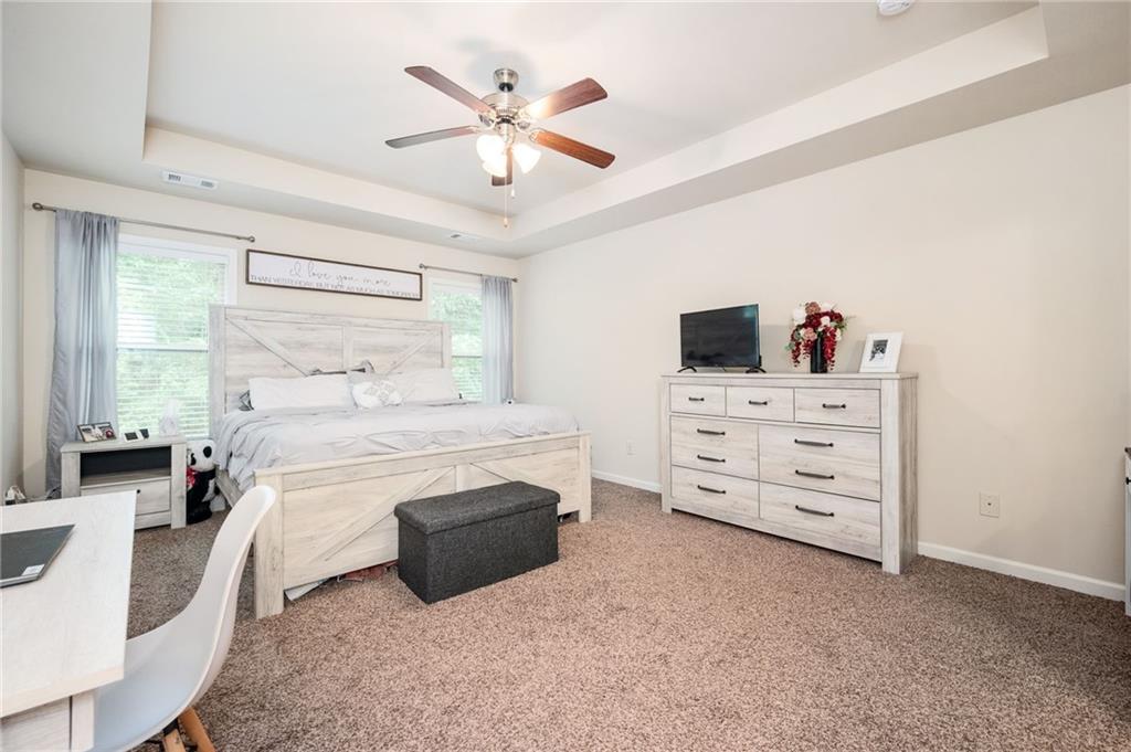 403 Franklin Lane Acworth, GA 30102 - Photo 17 of 26 a bedroom with a bed and a chandelier