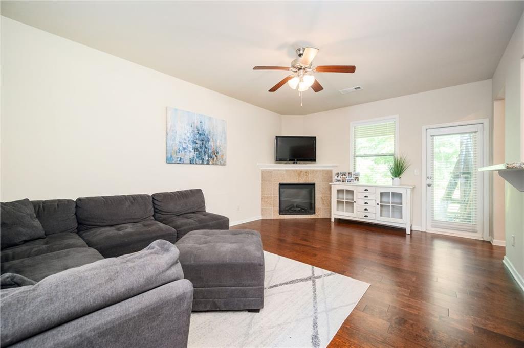 403 Franklin Lane Acworth, GA 30102 - Photo 2 of 26 a living room with furniture a fireplace and a flat screen tv