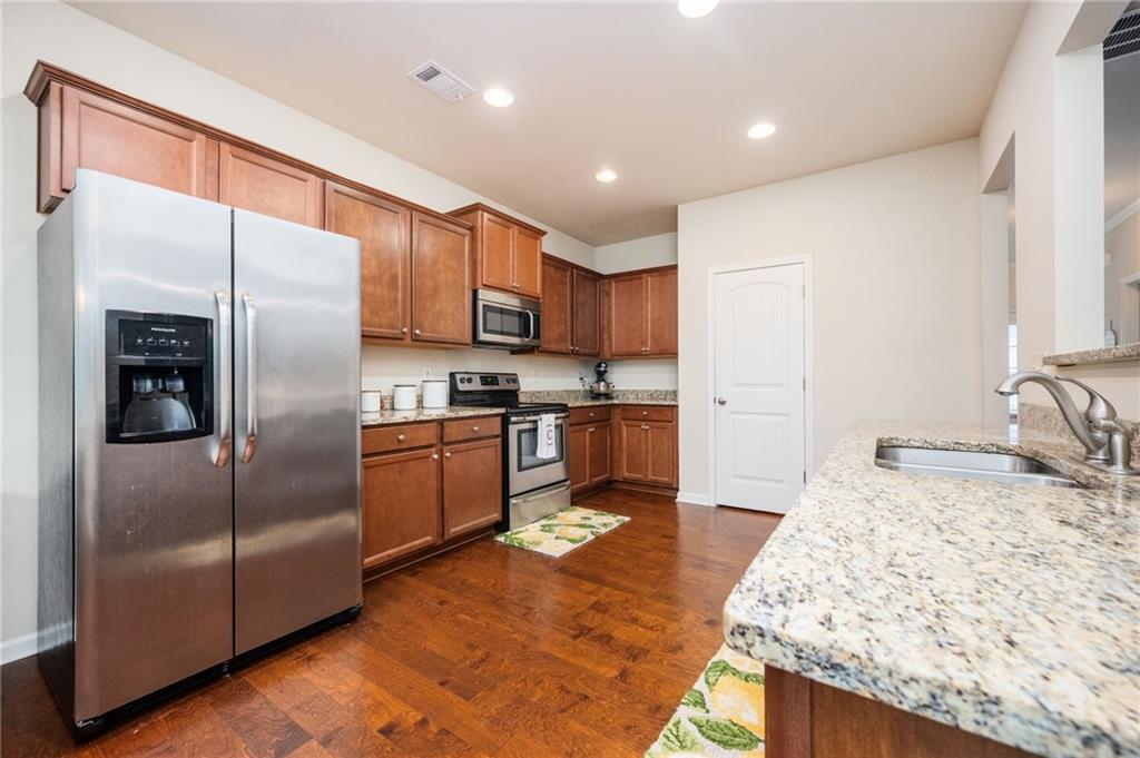 403 Franklin Lane Acworth, GA 30102 - Photo 3 of 26 a kitchen with granite countertop a refrigerator and a sink