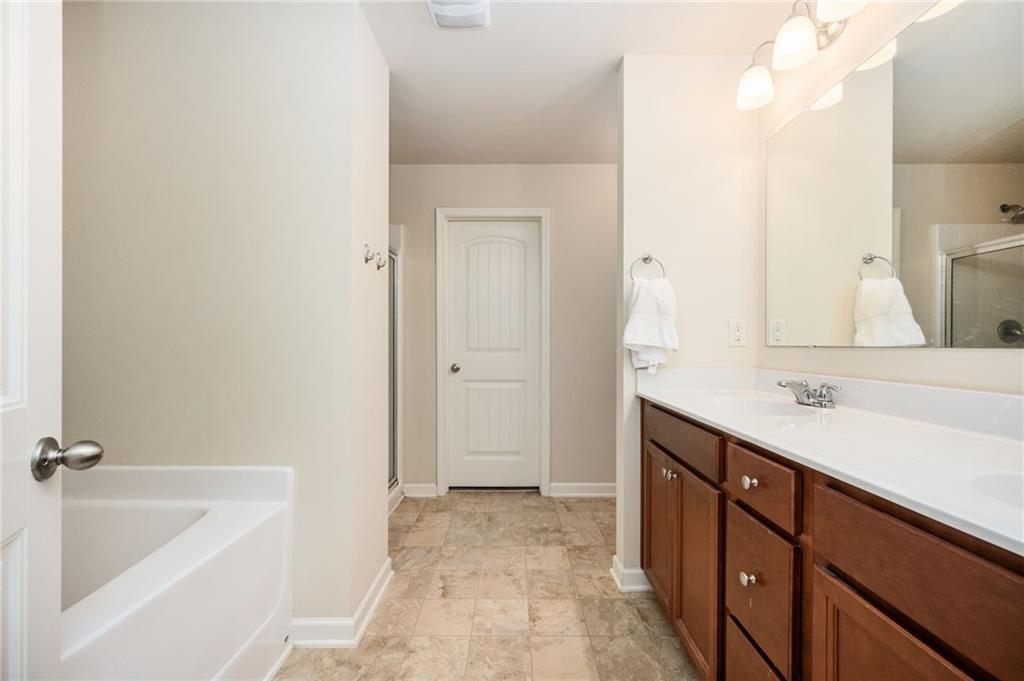 403 Franklin Lane Acworth, GA 30102 - Photo 6 of 26 a bathroom with a tub sink and mirror