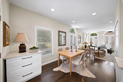 a living room with fireplace furniture and a wooden floor