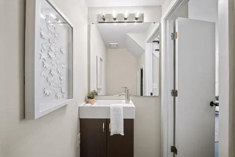 a bathroom with a sink a mirror a shower and a mirror