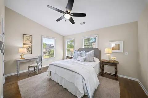 a bedroom with a bed a table and chair