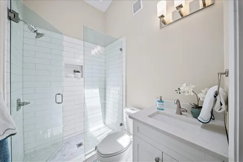 a bathroom with a sink a toilet and shower