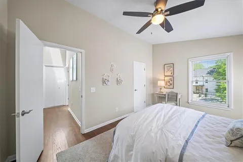 a bedroom with a large bed and a chandelier