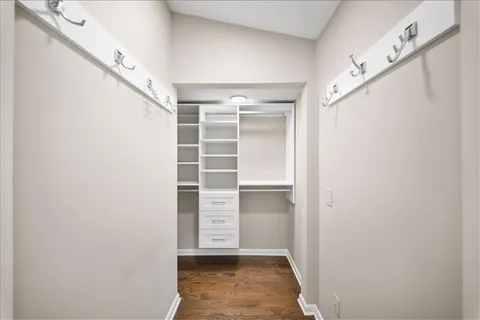 a view of walk in closet with empty racks