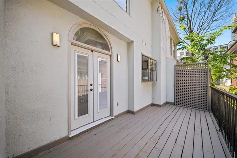 a view of a hallway with wooden floor and a yard