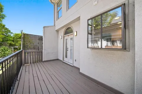 a view of a house with wooden floor next to a window