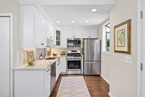 a kitchen with stainless steel appliances granite countertop a refrigerator stove a sink and dishwasher