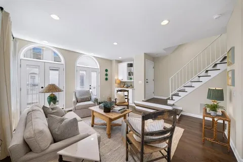 a living room with furniture and wooden floor