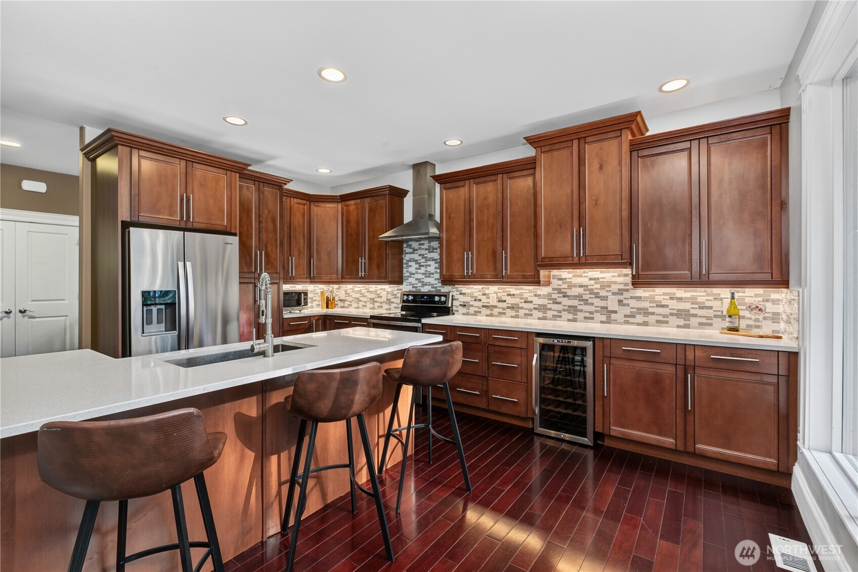 45 Cascade Lane Bellingham, WA 98229 - Photo 11 of 40 a kitchen with stainless steel appliances granite countertop a stove a sink dishwasher and a refrigerator with wooden floor