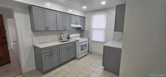 a utility room with cabinets washer and dryer