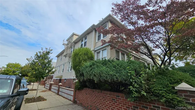 a view of house with outdoor space and trees