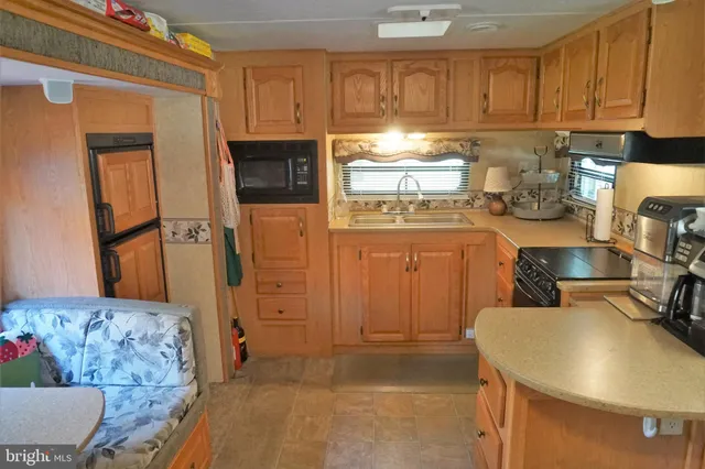 a kitchen with a refrigerator and a stove