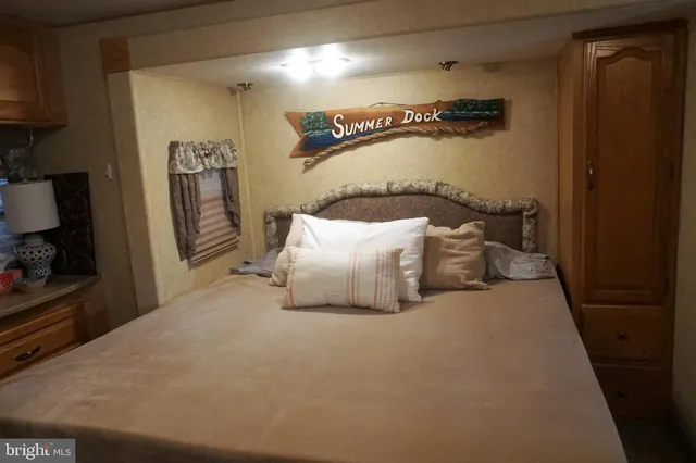 a bed room with a bed and a refrigerator