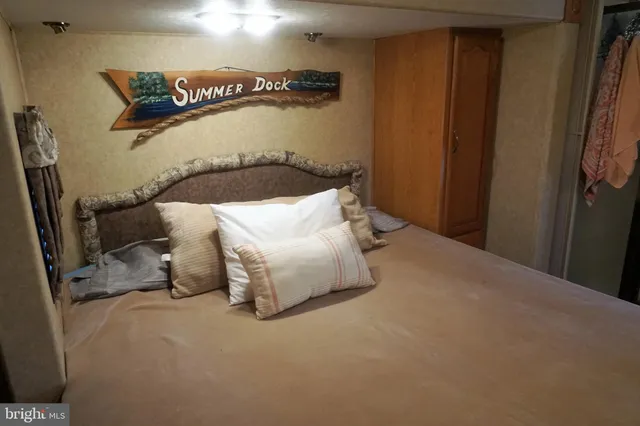 a bedroom with a bed and a night stand