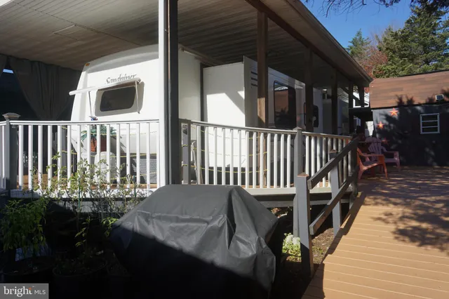 a view of a house with backyard porch and sitting area